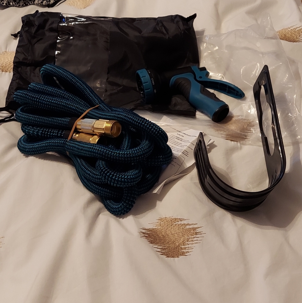 Garden Hose, sprayer and hangar.